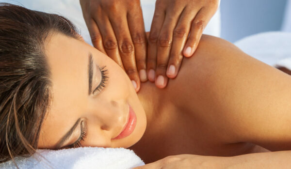 Woman relaxing with eyes closed during a shoulder massage