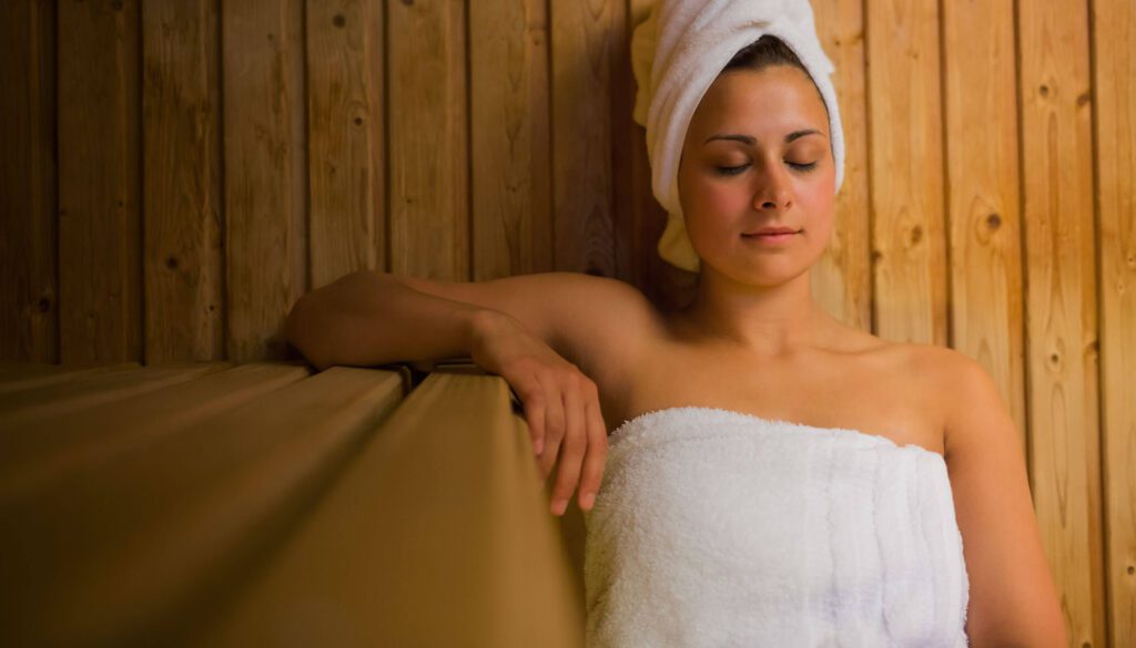 Guest relaxing during an infrared sauna session