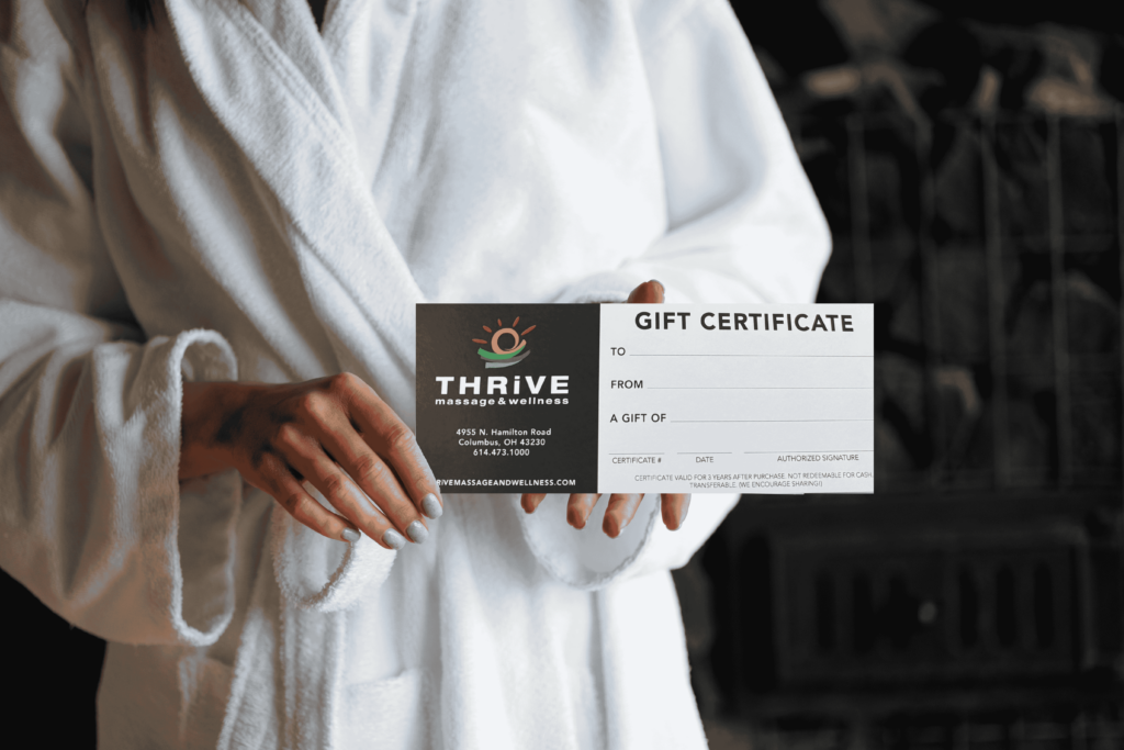 Hand holding a Thrive gift card